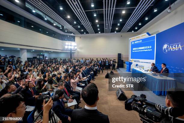 Journalists attend a press conference and the launch of annual reports during the Boao Forum for Asia Annual Conference 2024 in Boao, in southern...