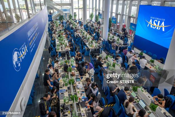 Journalists work at media center during the Boao Forum for Asia Annual Conference 2024 in Boao, in southern China's Hainan province on March 26,...