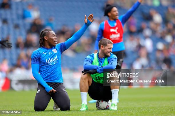 Brandon Thomas-Asante and John Swift of West Bromwich Albion react during an open training session at The Hawthorns on March 26, 2024 in West...
