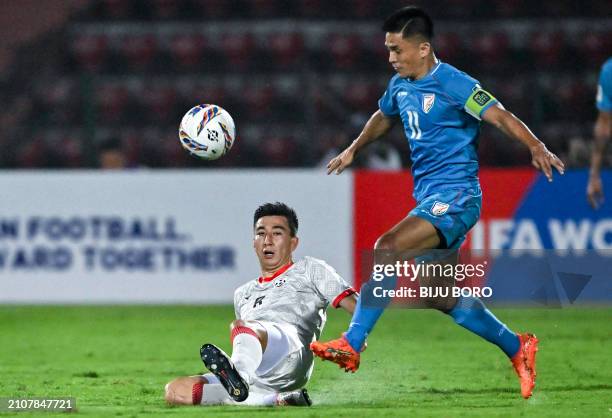 India's Sunil Chhetri fights for the ball with Afghanistan's Rahmat Akbari during the 2026 FIFA World Cup AFC qualifiers football match between India...