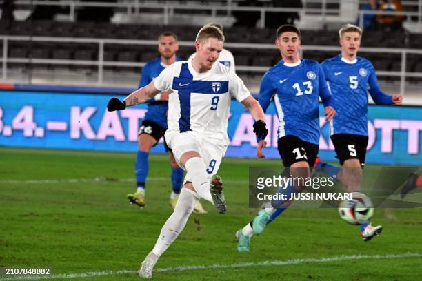 Finland's forward Fredrik Jensen shoots the penalty kick to score the 1-0 goal from rebound during the football friendly match Finland vs Estonia in...