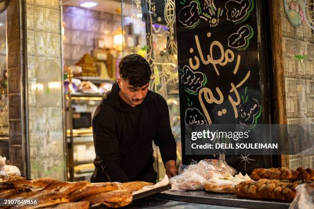 Man arranges "Maarouk", a sweet pastry usually stuffed with dates or other sweet fillings consumed during the Muslim holy fasting month of Ramadan,...