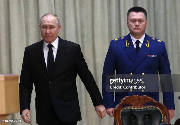 Russian President Vladimir Putin and Prosecutor General Igor Krasnov enter the hall during an annual expanded Prosecutor General's Office meeting,...