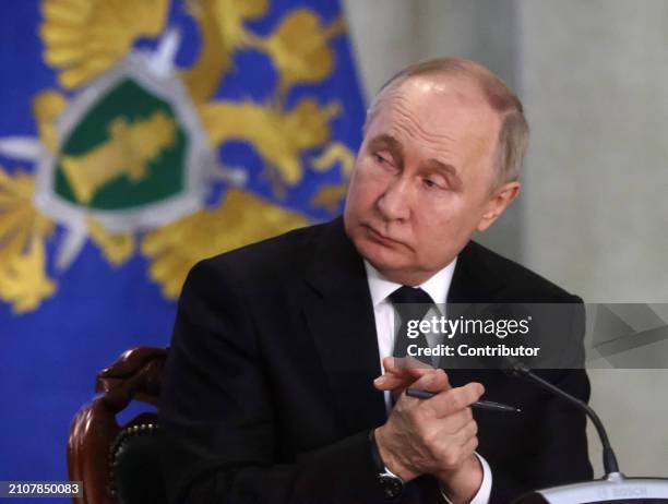 Russian President Vladimir Putin gestures during an annual expanded Prosecutor General's Office meeting, March 26 in Moscow, Russia. Dozens people...