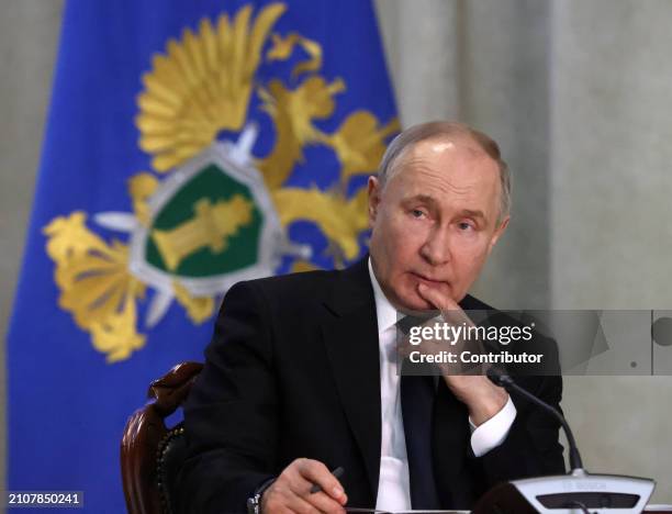 Russian President Vladimir Putin grimaces during an annual expanded Prosecutor General's Office meeting, March 26 in Moscow, Russia. Dozens people...