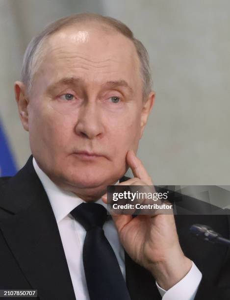 Russian President Vladimir Putin grimaces during an annual expanded Prosecutor General's Office meeting, March 26 in Moscow, Russia. Dozens people...