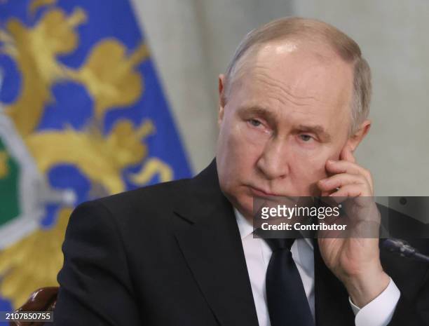 Russian President Vladimir Putin grimaces during an annual expanded Prosecutor General's Office meeting, March 26 in Moscow, Russia. Dozens people...