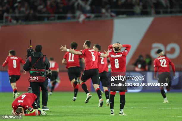 Georgia's players celebrate winning the UEFA EURO 2024 qualifying play-off final football match between Georgia and Greece in Tbilisi on March 26,...