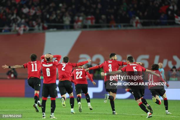 Georgia's players celebrate winning the UEFA EURO 2024 qualifying play-off final football match between Georgia and Greece in Tbilisi on March 26,...