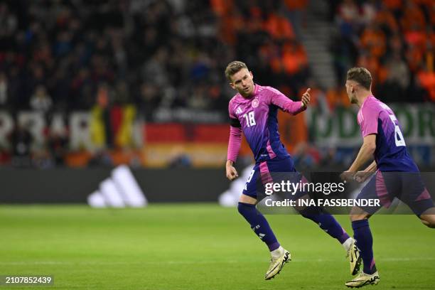 Germany's defender Maxmilian Mittelstadt celebrates with Germany's midfielder Joshua Kimmich after scoring the equalizing 1-1 goal during the...