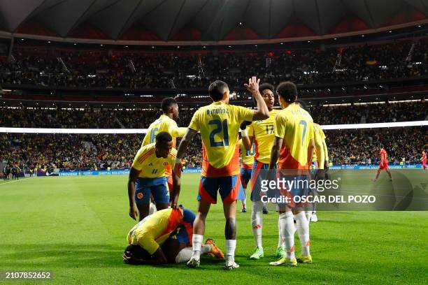 Colombia's forward Jhon Cordoba celebrates with teammates after scoring his team's first goal during the international friendly football match...