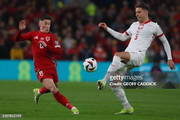 Wales' midfielder Harry Wilson and Poland's defender Jan Bednarek compete during the UEFA EURO 2024 qualifier play-off final first leg football match...