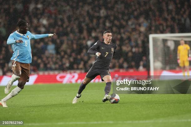 Belgium's Amadou Onana and England's Phil Foden fight for the ball during a friendly soccer game between England and Belgian national team Red...