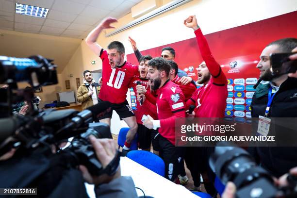 Georgia's players celebrate after winning the UEFA EURO 2024 qualifying play-off final football match between Georgia and Greece in Tbilisi on March...