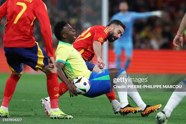 Brazil's forward Vinicius Junior is is tackled by Spain's defender Dani Carvajal during the international friendly football match between Spain and...