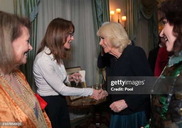 Queen Camilla speaking to Susie Dent during a reception to mark the findings of a new research study commissioned by The Queen's Reading Room...