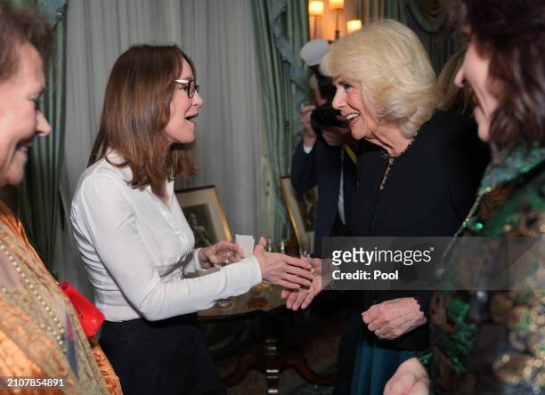 Queen Camilla speaking to Susie Dent during a reception to mark the findings of a new research study commissioned by The Queen's Reading Room...