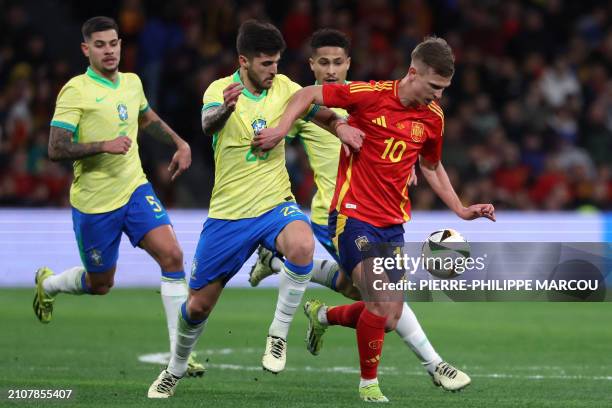 Spain's midfielder Dani Olmo fights for the ball with Brazil's defender Lucas Beraldo during the international friendly football match between Spain...