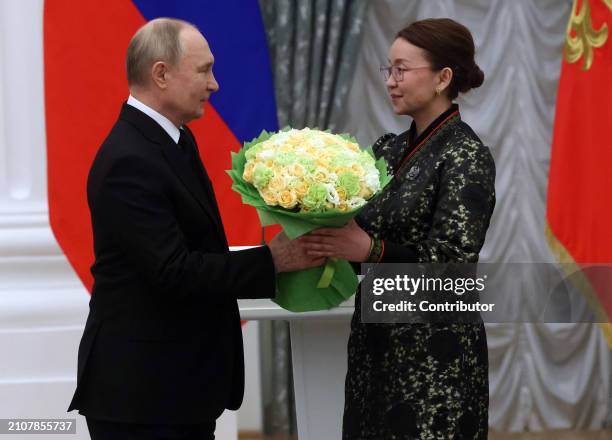 Russian President Vladimir Putin greets Tuvan Culture Center Director Mengi Ondar during the ceremony of State Awards for Youth Culture...