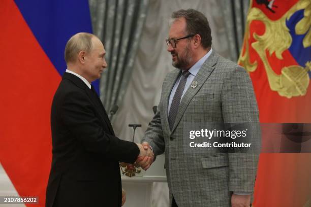 Russian President Vladimir Putin greets Ryazan Pappet Director Konstantin Kirillov during the ceremony of State Awards for Youth Culture...