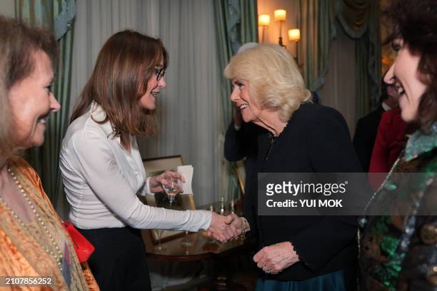 Britain's Queen Camilla speaks with British lexicographer Susie Dent during a reception to mark the findings of a new research study commissioned by...