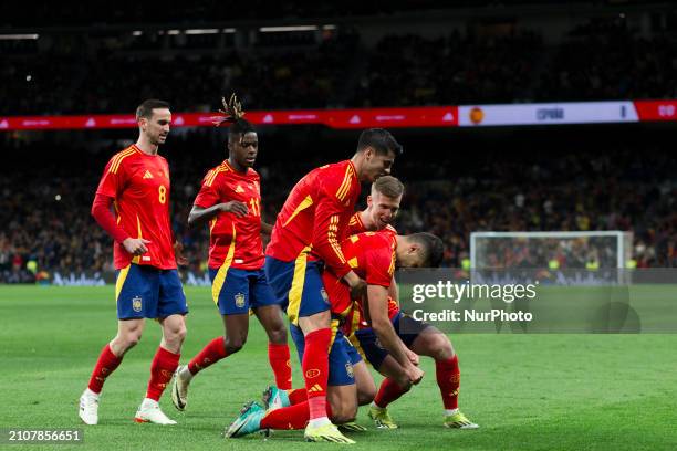 Several players from Spain are celebrating a goal during the friendly match between Spain and Brazil at Santiago Bernabeu Stadium in Madrid, Spain,...