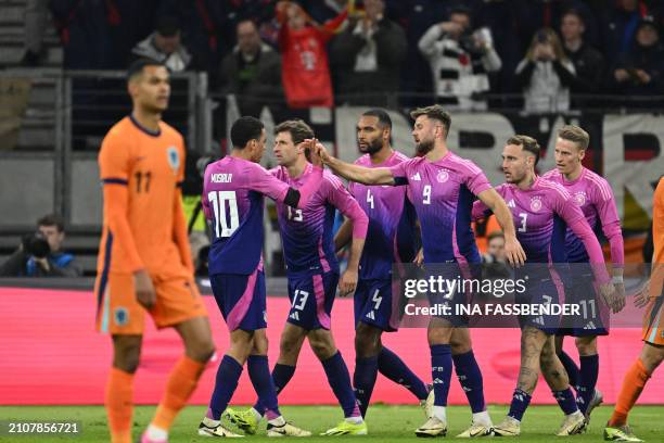 Germany's forward Niclas Fullkrug celebrates with team mates after scoring the 2-1 goal during the friendly football match between Germany and...