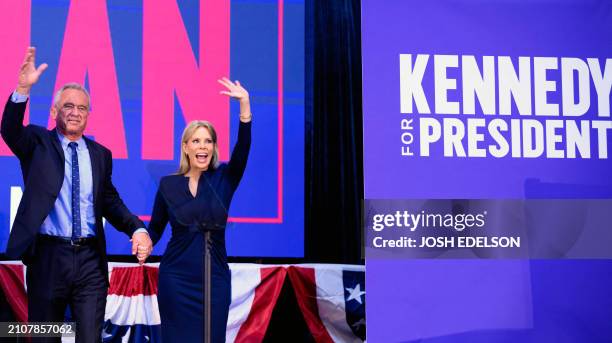 Independent presidential candidate Robert F. Kennedy Jr. Waves to a cheering crowd alongside his wife actress Cheryl Hines during a campaign event at...