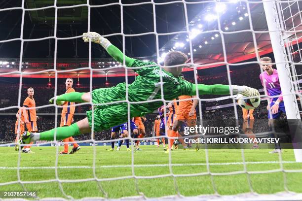 Netherlands' goalkeeper Bart Verbruggen gets a hand on the3 ball but fails to save the 2-1 goal during the friendly football match between Germany...