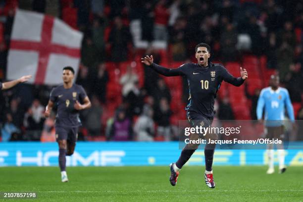 Jude Bellingham of England celebrates after scoring the late equalising goal during the international friendly match between England and Belgium at...