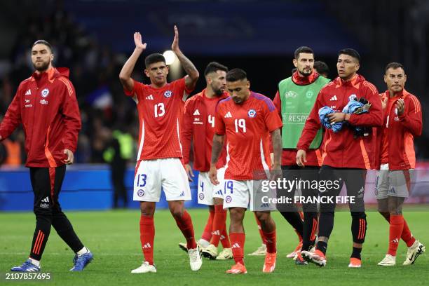 Chile's players including Chile's midfielder Esteban Pavez, Chile's defender Mauricio Isla and Chile's forward Marcos Bolados react at the end of the...