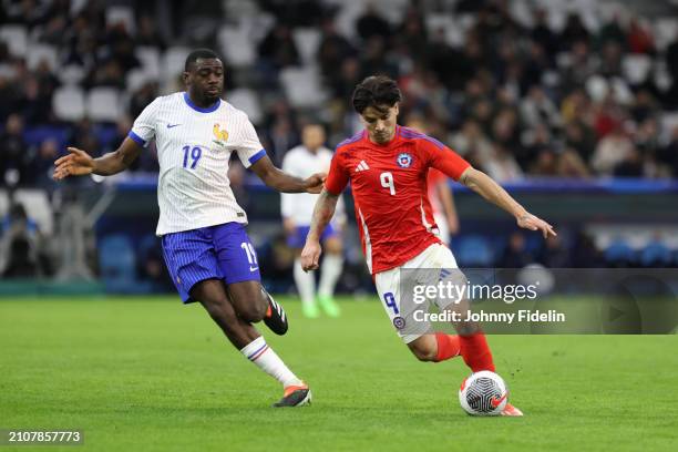 Youssouf FOFANA of France and Victor DAVILA of Chile during the friendly match between France and Chile at Orange Velodrome on March 26, 2024 in...