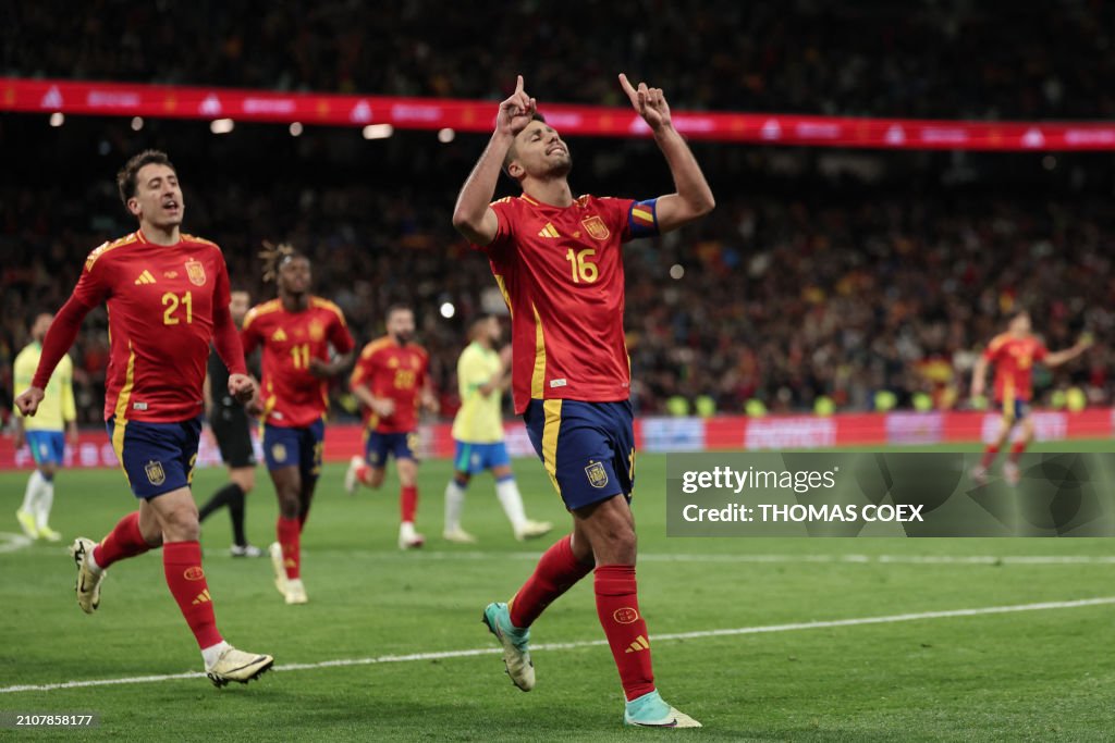 Spain Rhd TOPSHOT - Spain's midfielder Rodri celebrates scoring his team's ...