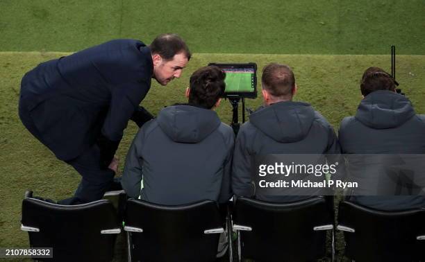 Dublin , Ireland - 26 March 2024; Republic of Ireland interim head coach John O'Shea consults with his staff during the international friendly match...