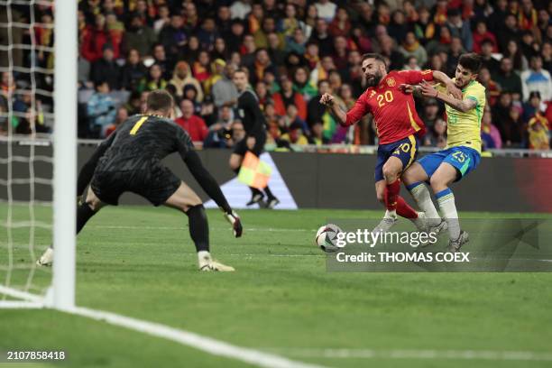 Spain's defender Dani Carvajal vies with Brazil's defender Lucas Beraldo during the international friendly football match between Spain and Brazil at...