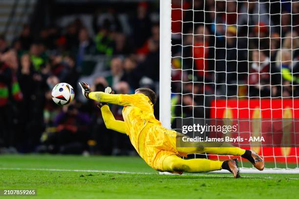 Wojciech Szczsny of Poland saves a penalty from Daniel James of Wales to win the penalty shoot out and qualify for EURO 2024 during the UEFA EURO...