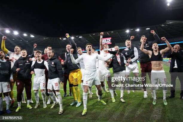 Jan Bednarek of Poland and teammates celebrate after the UEFA EURO 2024 Play-Offs Final match between Wales and Poland at Cardiff City Stadium on...