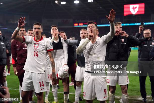 Poland's Robert Lewandowski, Jakub Kiwior and team-mates celebrate after winning the penalty shoot out during the UEFA Euro 2024 Qualifying play-off...