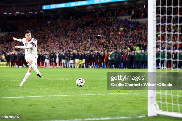 Robert Lewandowski of Poland scores his penalty in the shootout during the UEFA EURO 2024 Play-Offs Final match between Wales and Poland at Cardiff...