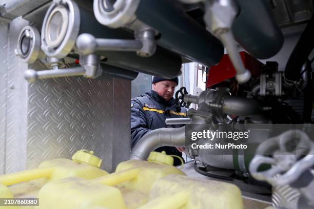 Rescuer is standing by a fire engine that German firefighter Nils Thal has conveyed to his colleagues in Kharkiv, northeastern Ukraine, on March 26,...