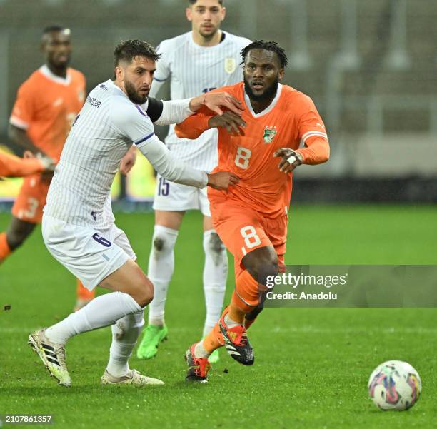 Franck Kessie of Ivory Coast in action against Bentancur Colman of Uruguay during the international friendly football match between Ivory Coast and...