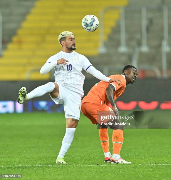 Seri Jean Michael of Ivory Coast in action against De Arrascaeta Benedetti of Uruguay during the international friendly football match between Ivory...