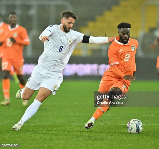 Jonathan Bamba R) of Ivory Coast in action against Bentancur Colman of Uruguay during the international friendly football match between Ivory Coast...