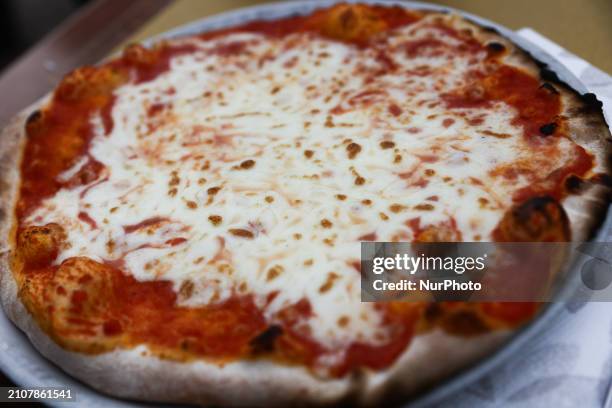 Pizza is seen at restaurant table in this illustration photo taken in Rome, Italy on March 25, 2024.