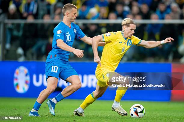 Albert Gudmundsson of Iceland and Mykhailo Mudryk of Ukraine battle for the ball during the UEFA EURO 2024 Play-Offs final match between Ukraine and...