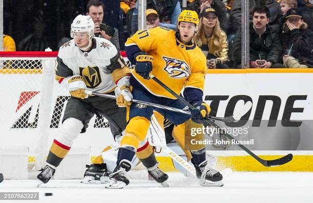 Mark Jankowski of the Nashville Predators battles in front of the net against Ben Hutton of the Vegas Golden Knights during an NHL game at...