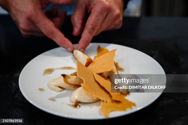 French pastry chef and creative director of Valrhona chocolaterie Frederic Bau prepares a pure fondant dessert with 'blond' chocolate, oven-roasted...