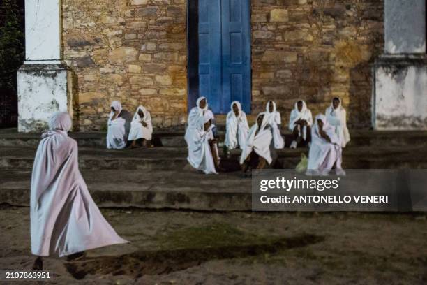 Catholic women dressed in white sheets take part in the Terno das Almas procession in Igatu on the Chapada Diamantina National Park, Bahia State,...