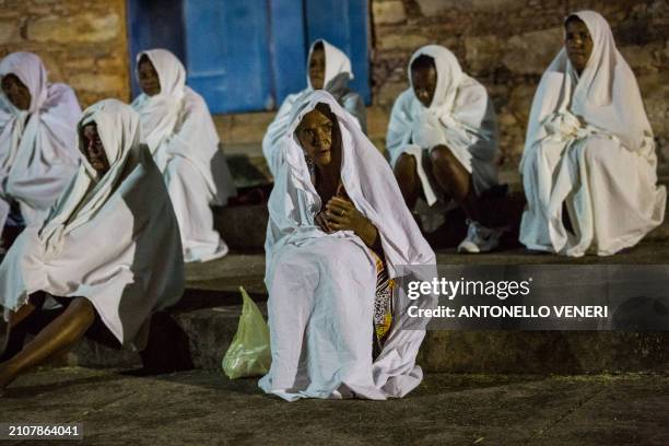 Catholic women dressed in white sheets take part in the Terno das Almas procession in Igatu on the Chapada Diamantina National Park, Bahia State,...