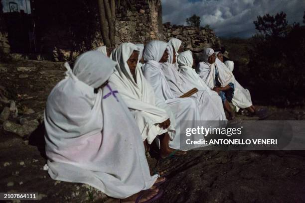 Catholic women dressed in white sheets take part in the Terno das Almas procession in Igatu on the Chapada Diamantina National Park, Bahia State,...